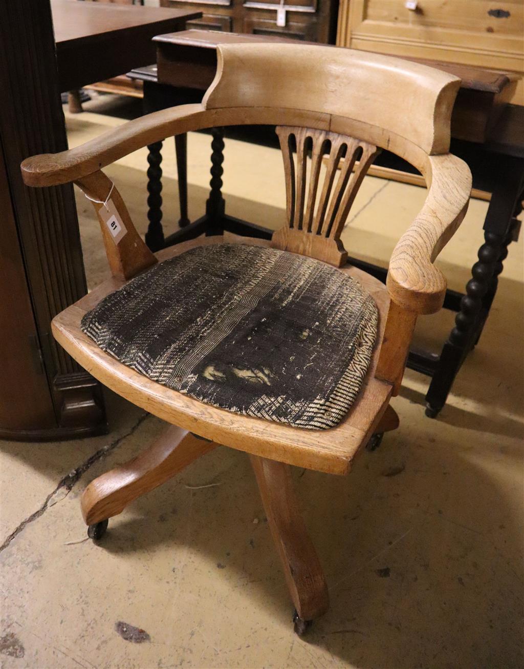 An early 20th century oak tub framed desk chair